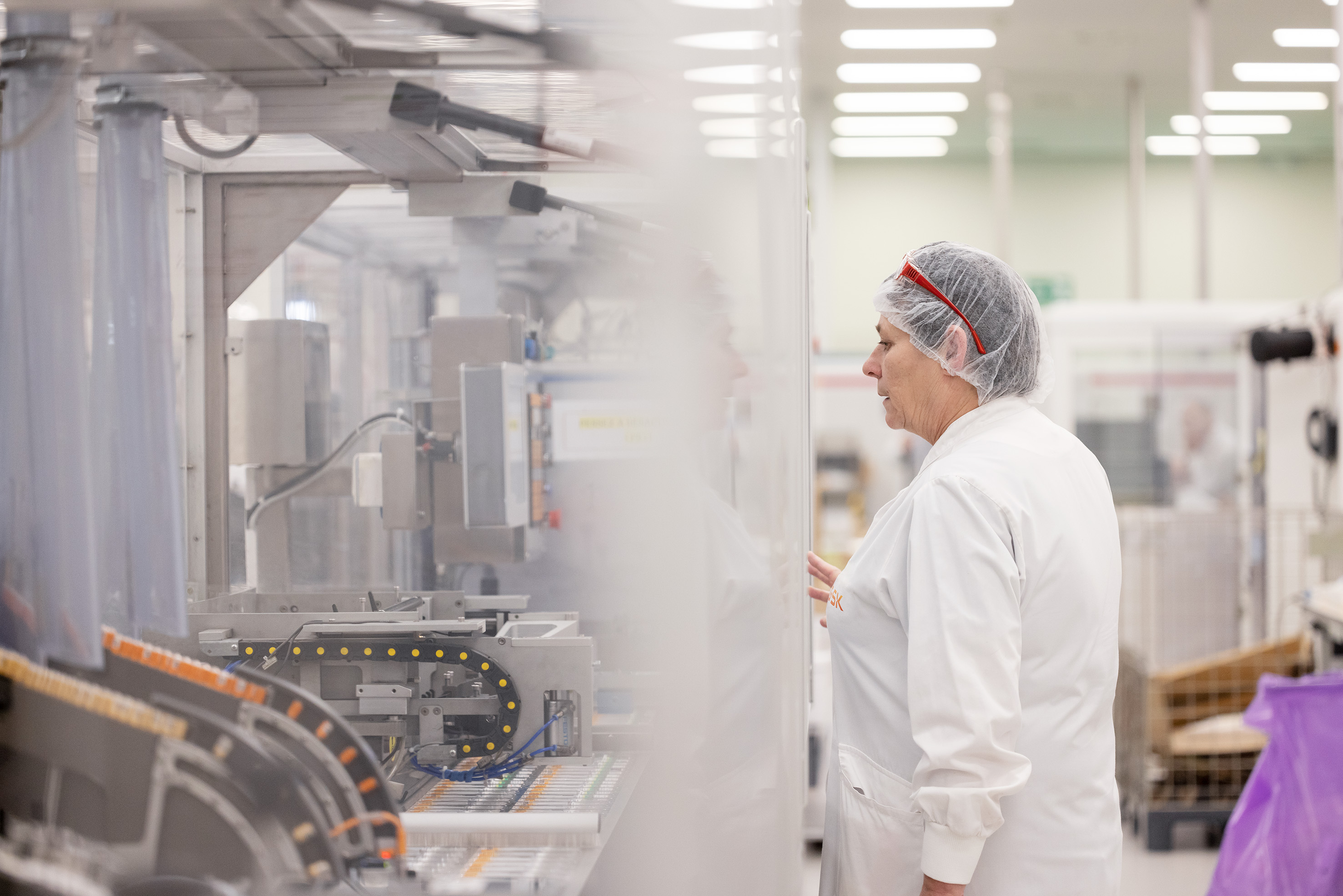 Une scientifique concentrée sur son travail sur une machine en laboratoire
