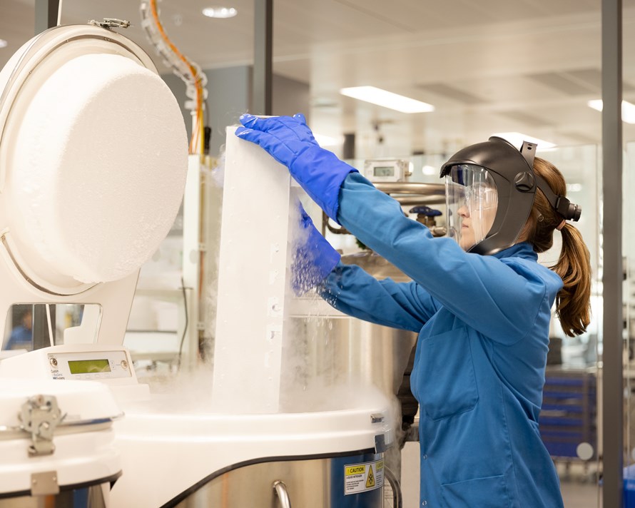 Female scientist in a lab with machine