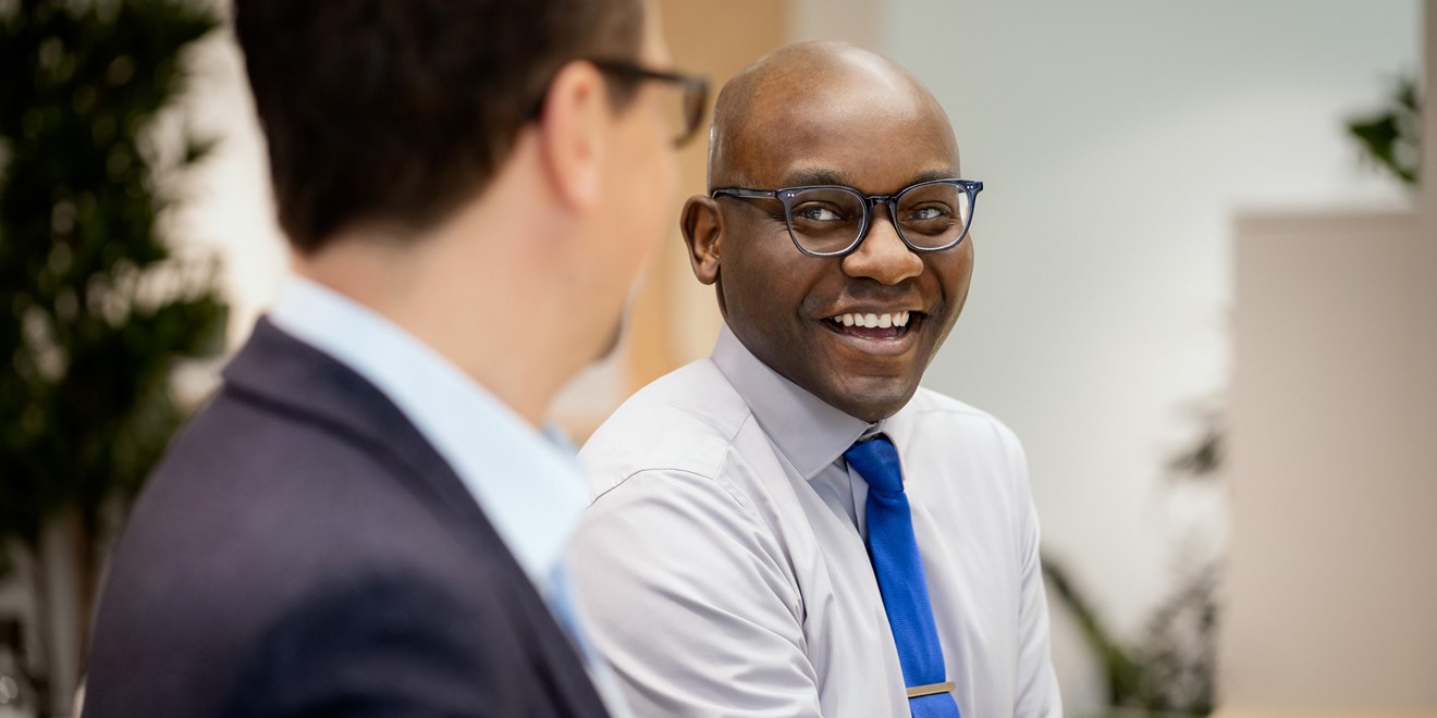 Male employees smiling in an office
