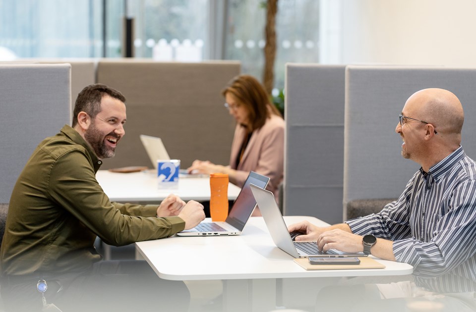 Male employees laughing together in an office