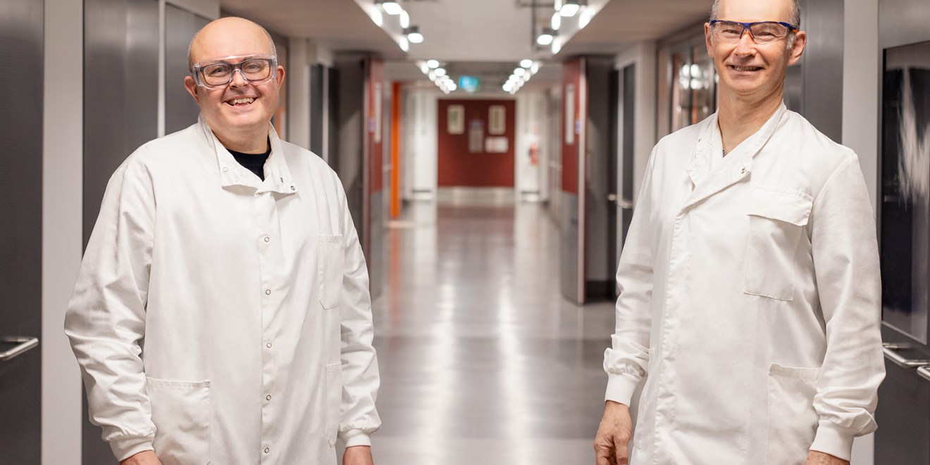 Two male scientists in a hall
