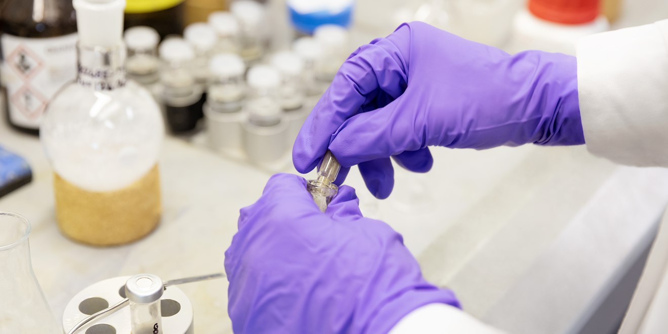 Scientist working on a vial in a laboratory