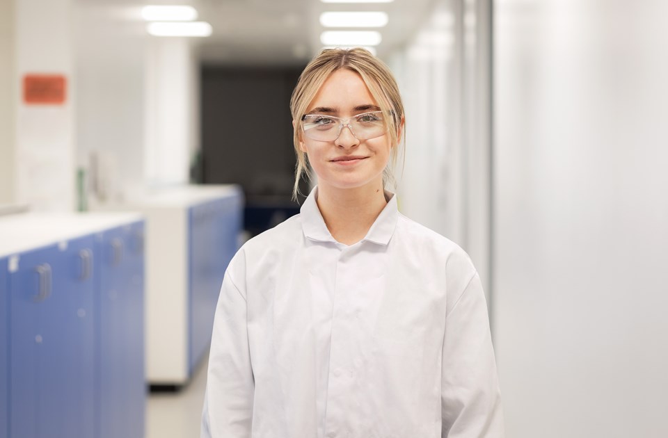 Female scientist smiling in a laboratory