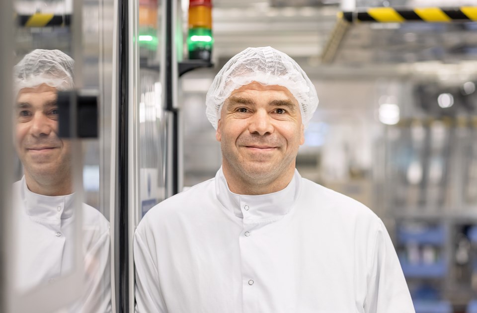 Male employees posing and smiling in a laboratory