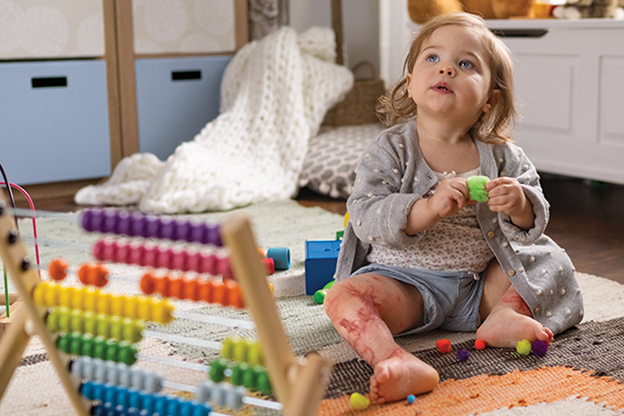 Female toddler playing with toys in a house