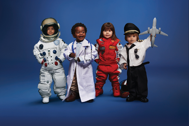 Four children dressed as pilot, astronaut, racing car driver and doctor