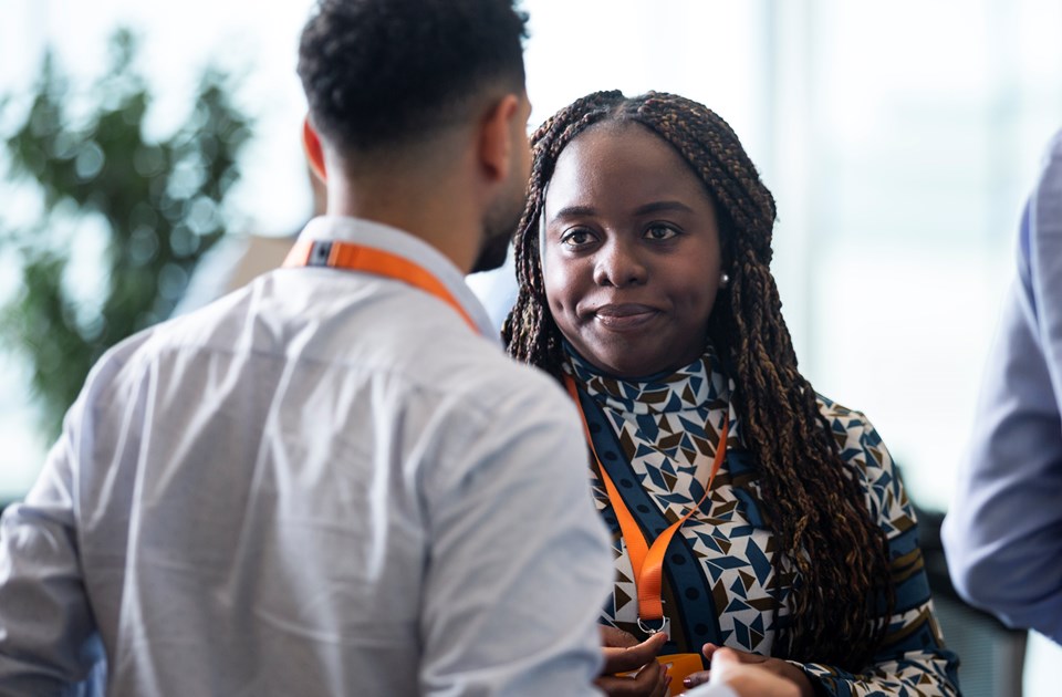 young black woman talking to male colleague