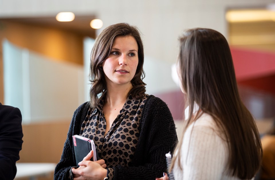 Two young women talking to each other