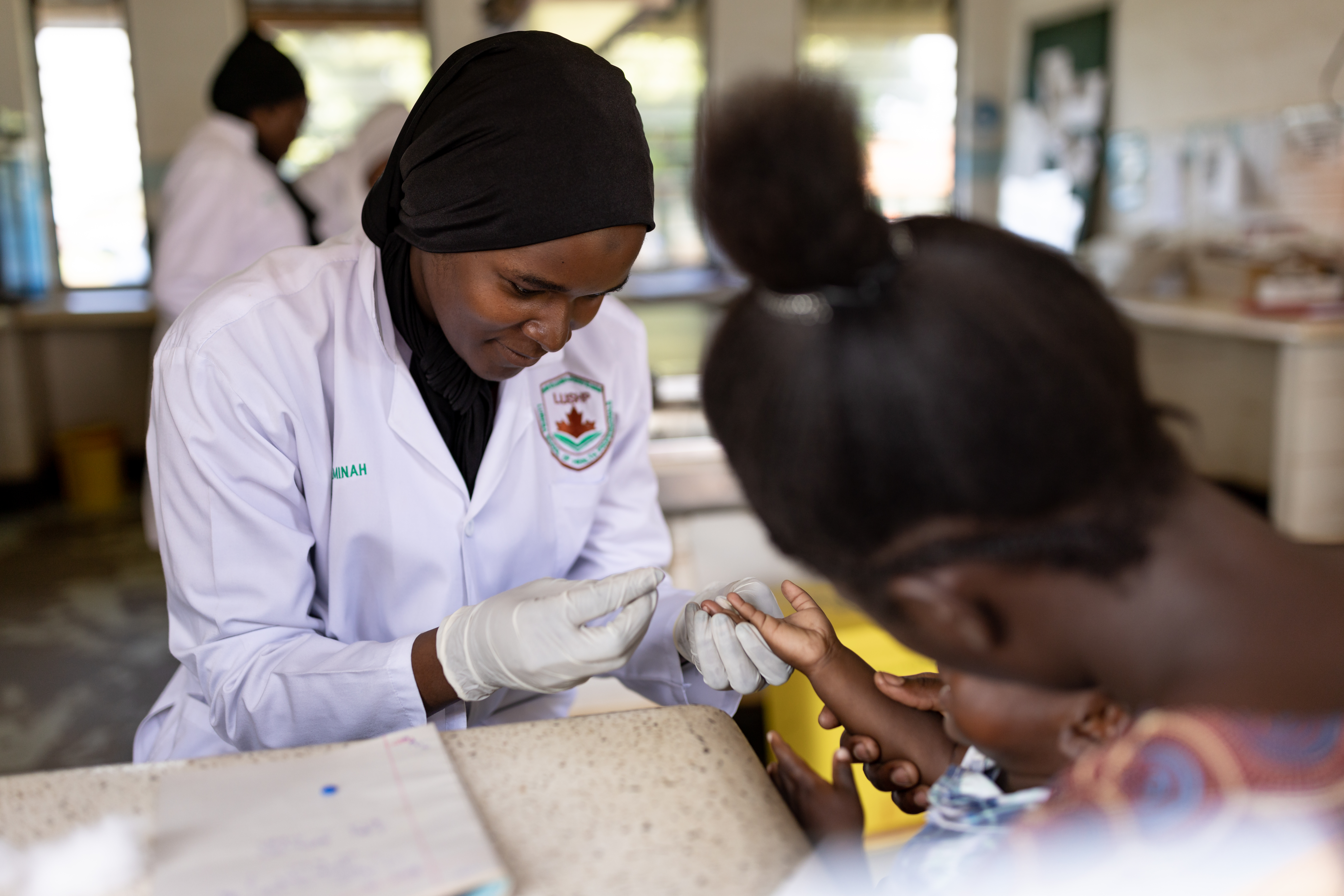 Physician administrating a vaccine to a toddler