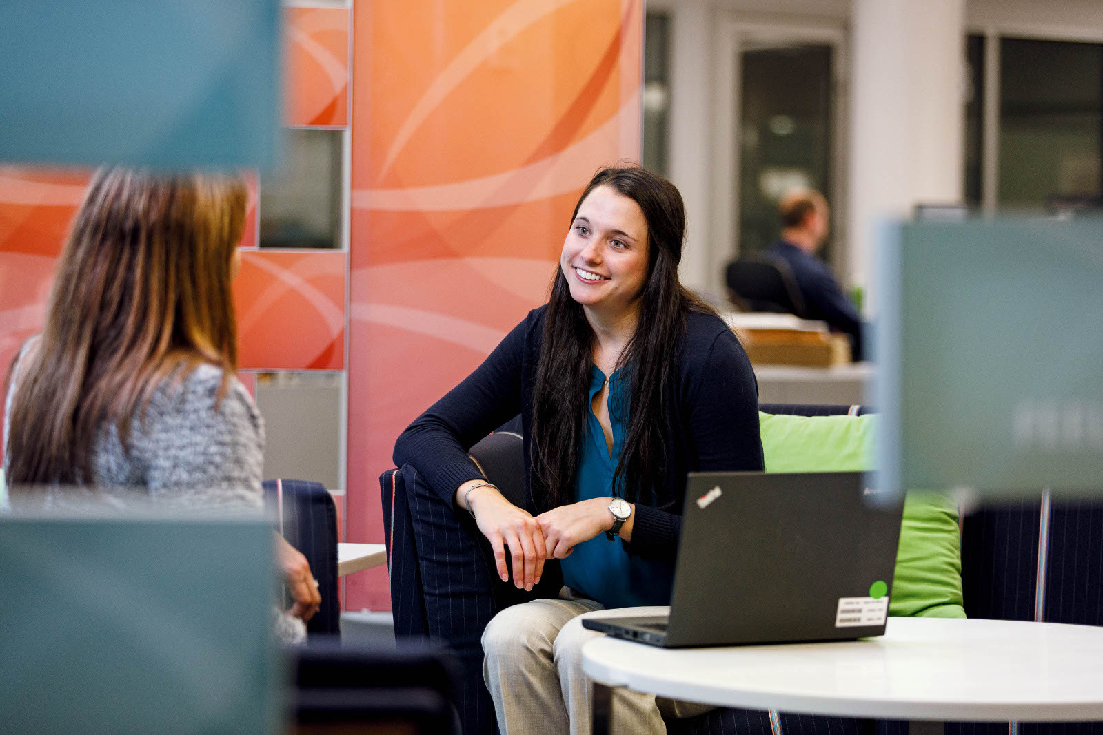 Kelly talking with a colleague