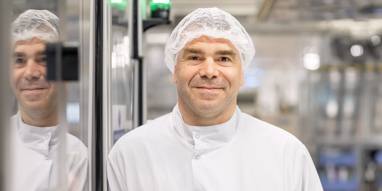 Male employees posing and smiling in a laboratory