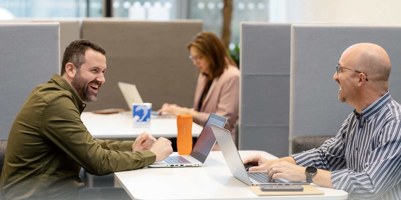 Male employees laughing together in an office