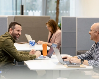 Male employees laughing together in an office