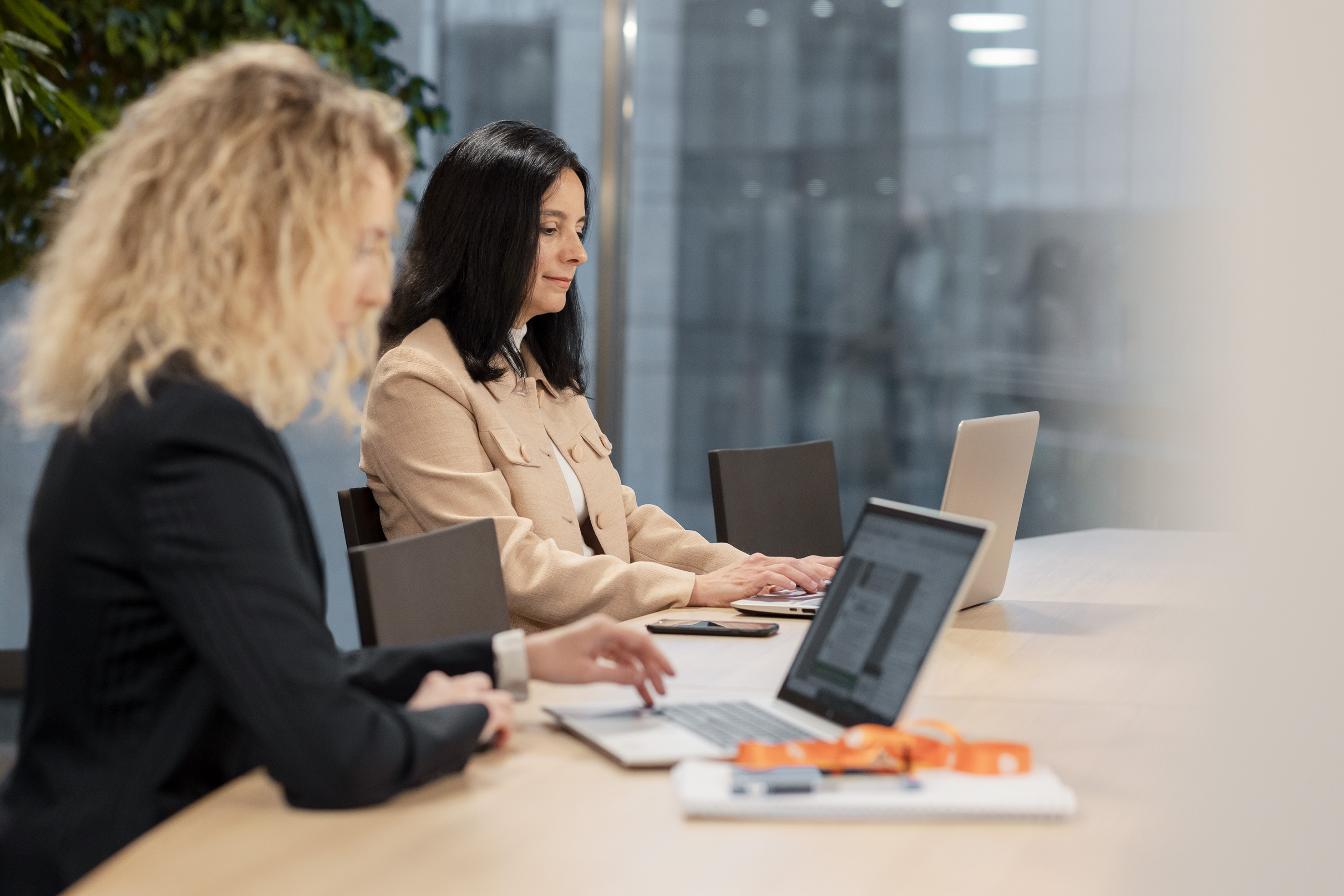 Two women working on their laptop