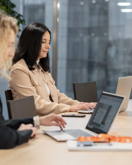 Two women working on their laptop