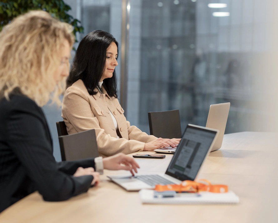Two women working on their laptop
