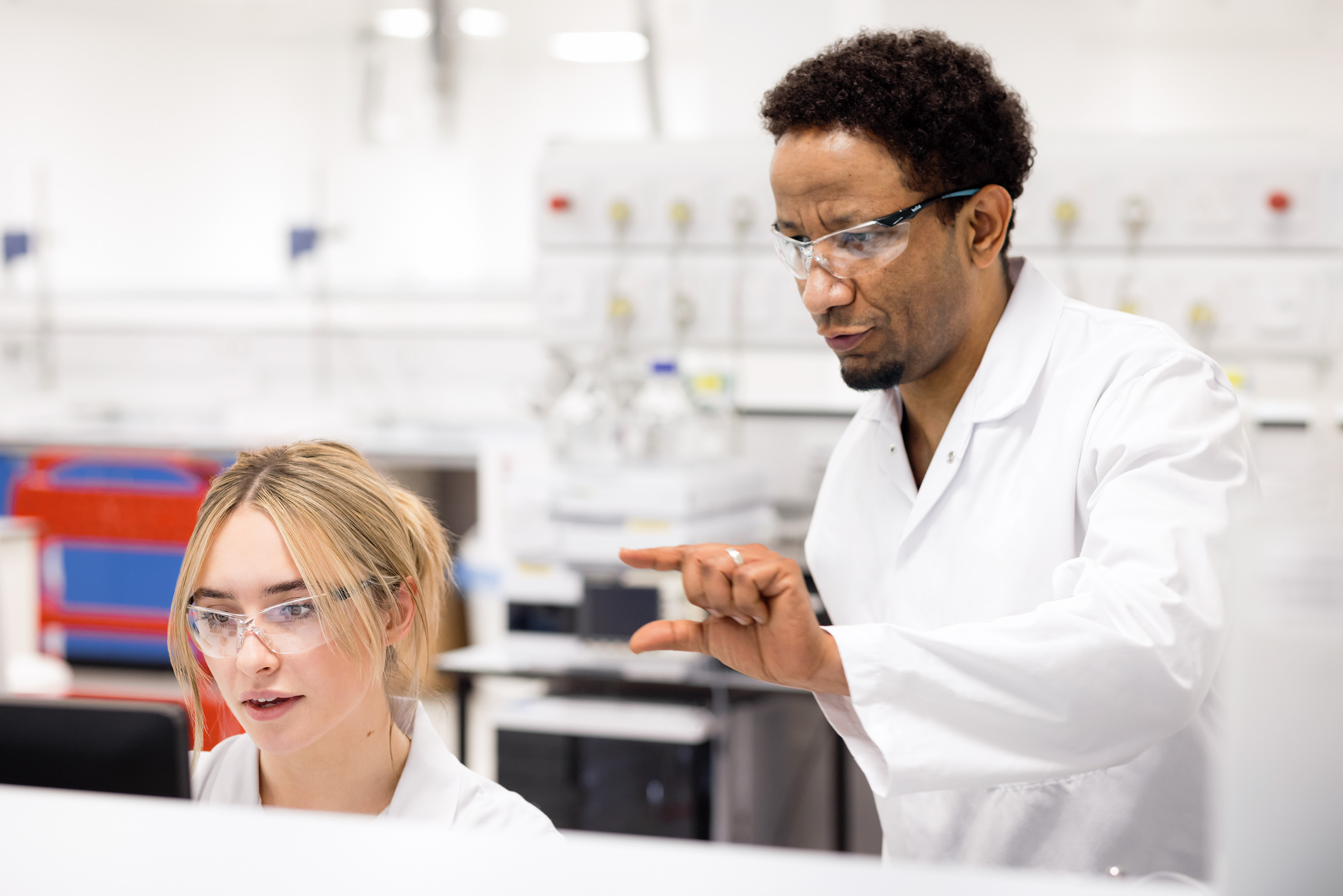 Two scientists talking and working together