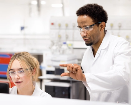 Two scientists talking and working together