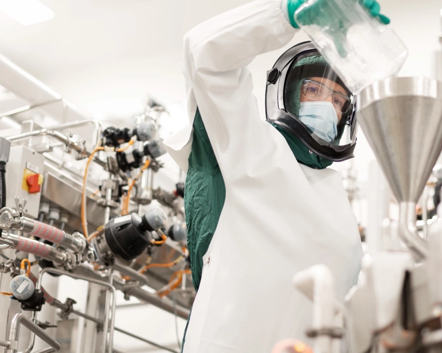 Scientist pouring a liquid into a machine