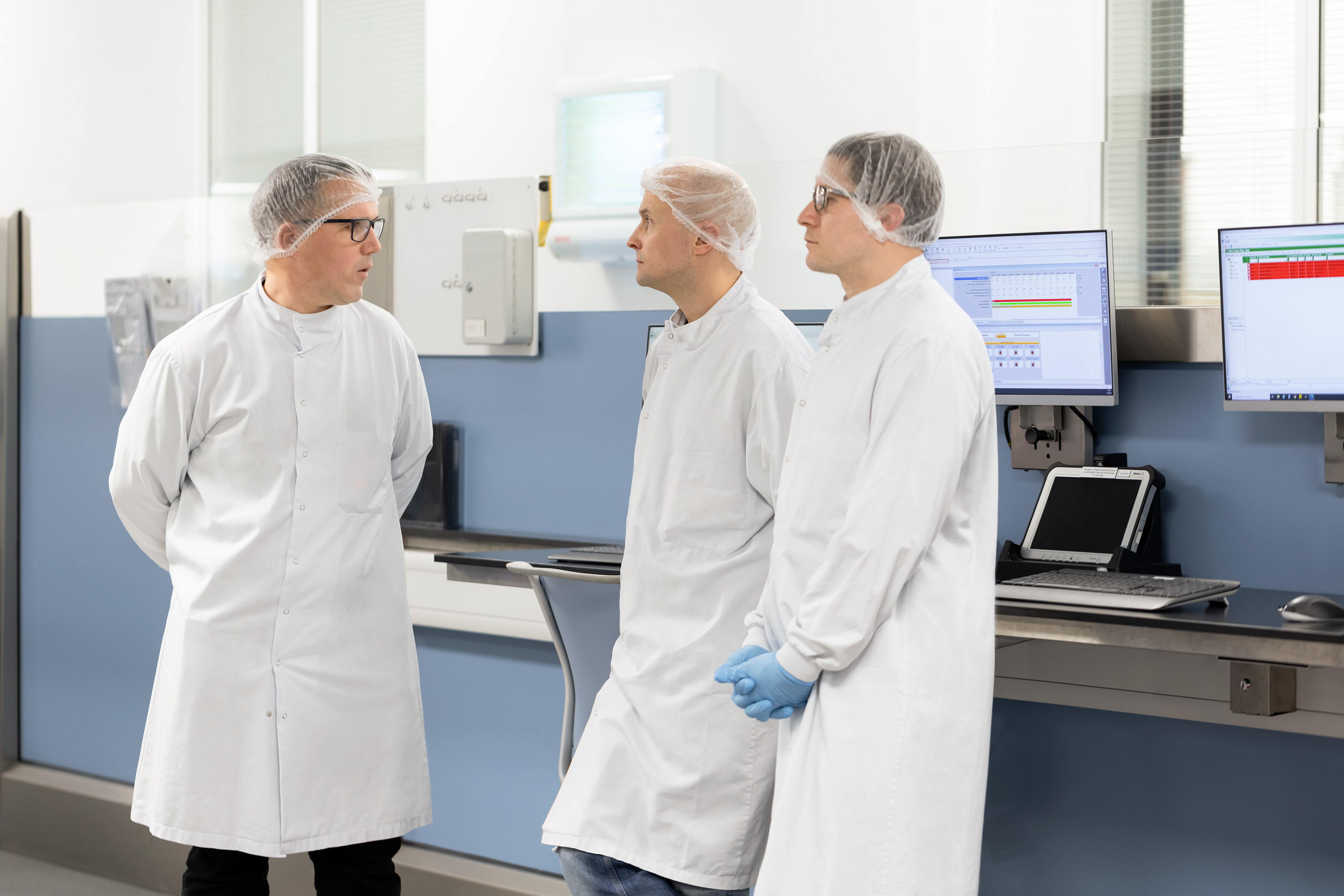 Three male scientists talking together