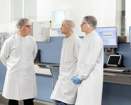 Three male scientists talking together