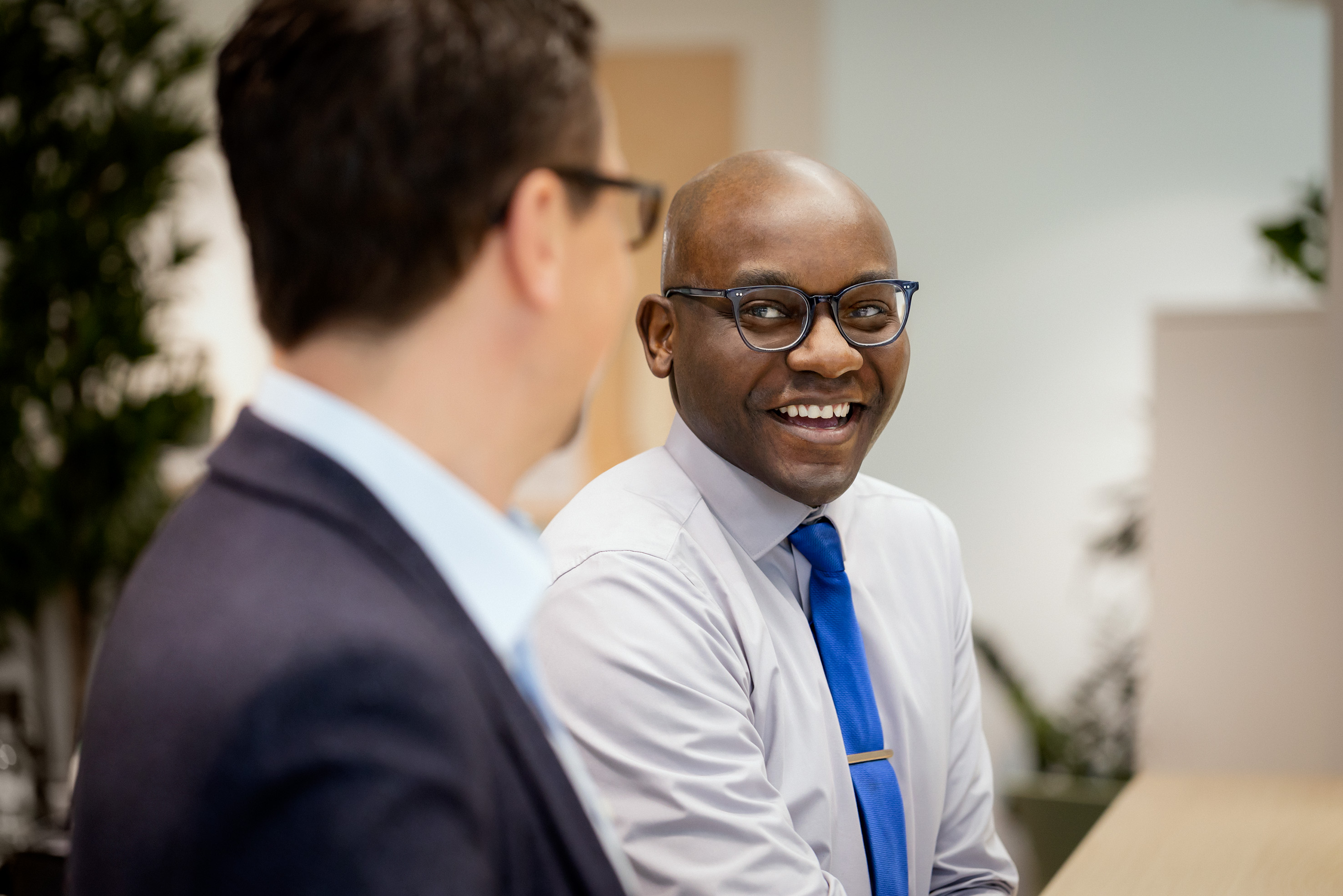 Male employees smiling in an office