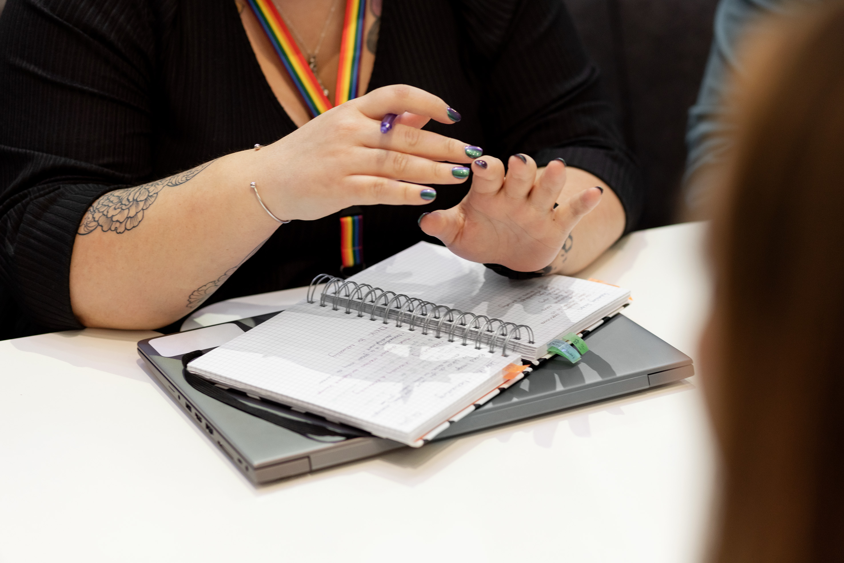 Two female employees talking at a desk