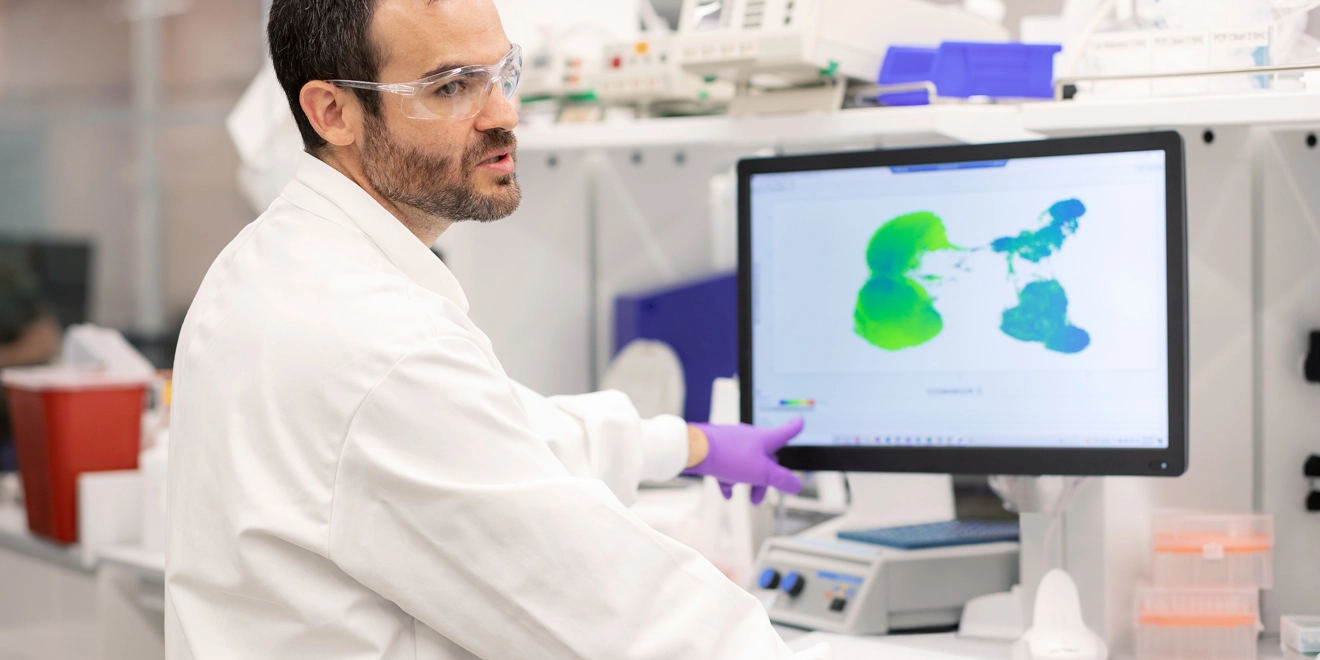 Un scientifique pointe du doigt un écran dans un laboratoire